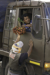 Rear view of man standing at bus