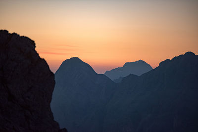 Scenic view of silhouette mountains against sky during sunset