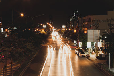 Cars on illuminated street at night