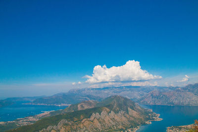 Scenic view of mountains against blue sky