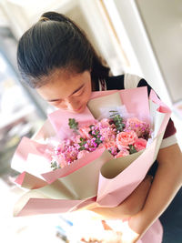 Close-up of young woman holding bouquet