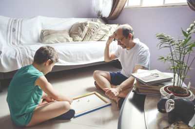 Father and child son playing glazing balls at home. happy home concept. salvador, bahia, brazil.