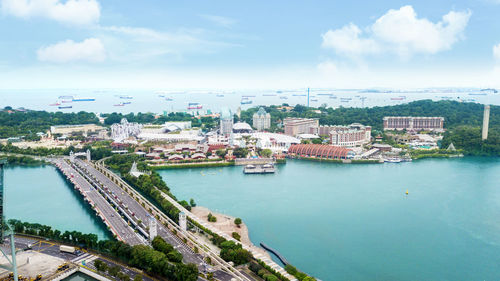 High angle view of buildings by sea against sky