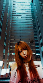 Portrait of young woman looking at city