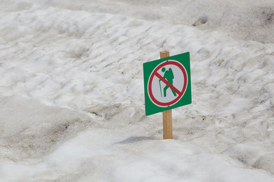 Road sign on snow covered land