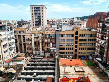 High angle view of buildings in city against sky