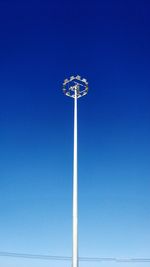 Low angle view of street light against blue sky