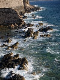 High angle view of rock formations in sea