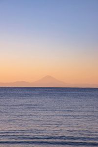 Scenic view of sea against clear sky during sunset