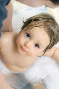 Close-up portrait of cute baby girl in bathroom