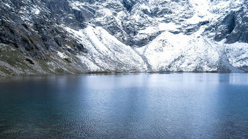 Czarny staw pod rysamy or black pond lake near the morskie oko snowy mountain hut in polish tatry