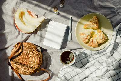 Morning breakfast in bed on blanket with tea, fruit and pie. summer mood inspiration.