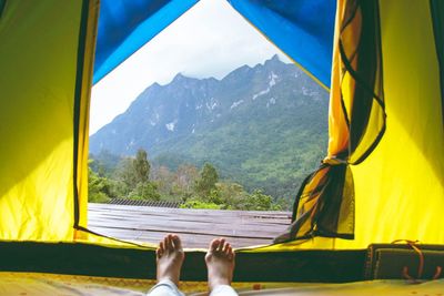 Low section of woman relaxing in tent