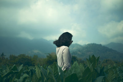 Rear view of man on landscape against sky