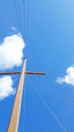 Low angle view of cables against blue sky