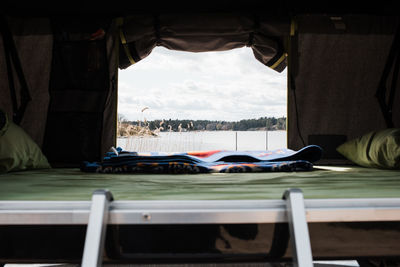 View of a lake from the window of a roof top tent