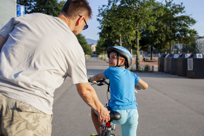 Side view of man riding bicycle on road