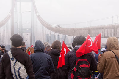 Rear view of people on bridge