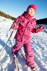 Full length of girl skiing on snow
