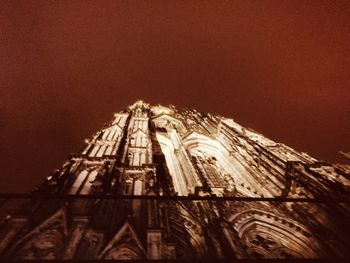 Low angle view of illuminated building against sky at night