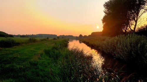 Scenic view of landscape against sky during sunset