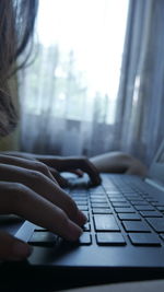 Midsection of woman using laptop