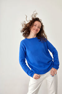 Portrait of smiling young woman against white background