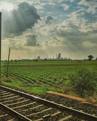 Scenic view of field against cloudy sky