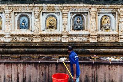 Rear view of man working on building