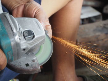 Midsection of man working in factory