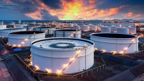 Storage of chemical products like oil, petrol, gas, aerial view oil storage tank terminal and tanker