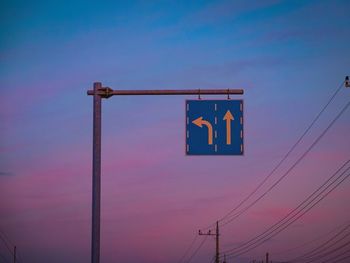 Low angle view of telephone pole against blue sky