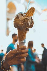 Close-up of hand holding ice cream