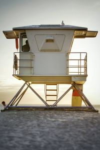 Low angle view of lifeguard hut on beach against sky