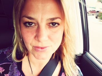 Portrait of smiling woman in car