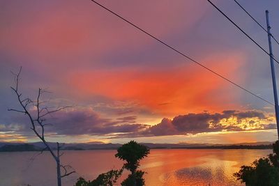 Scenic view of sea against romantic sky at sunset