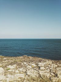 Scenic view of sea against clear blue sky