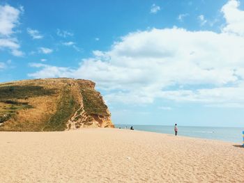 Man standing on beach against sky