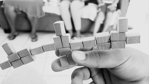 Close-up of human hand playing with toy at home