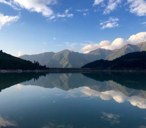 Scenic view of lake and mountains against sky