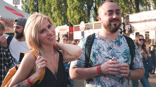 Portrait of smiling young couple standing outdoors