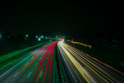 High angle view of light trails on highway at night