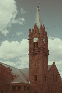 Low angle view of clock tower against sky