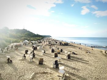 High angle view of hooded chairs at sandy beach