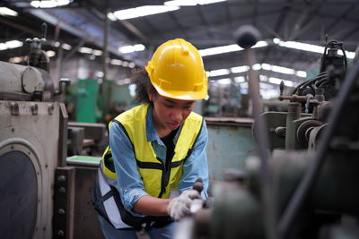 Rear view of man working in factory