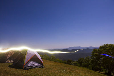 Tent on mountain against sky at night
