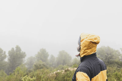 Hiker on his back breathing fresh air high in the mountains on a foggy day