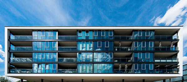 Low angle view of apparment house against blue sky