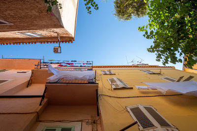 Low angle view of residential building against clear blue sky