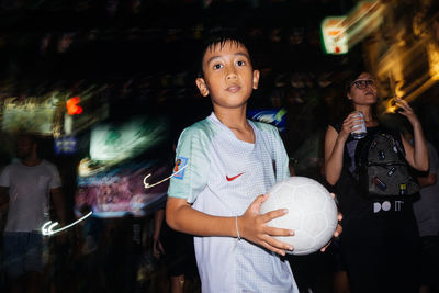 Full length of friends standing with ball in hair